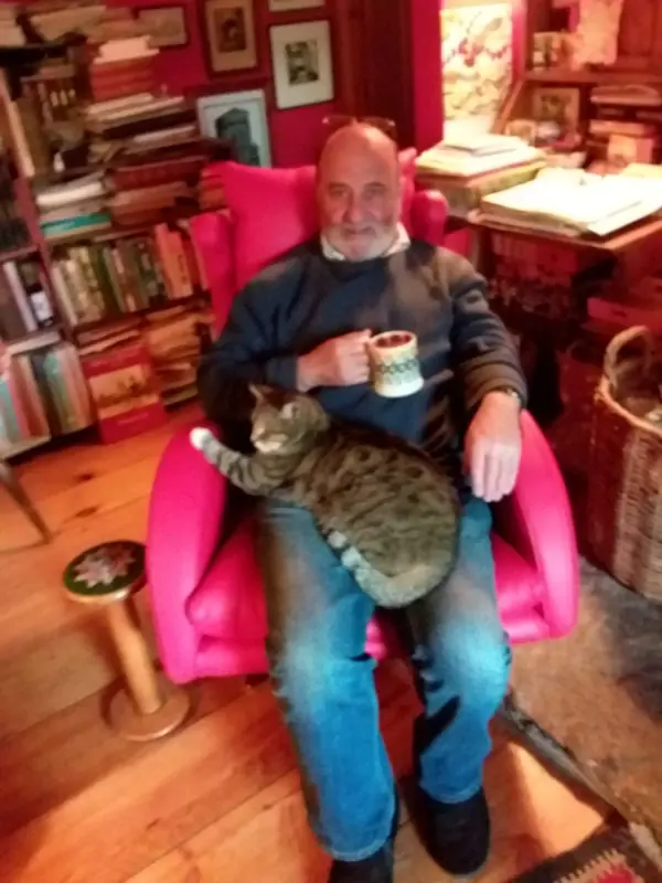 Ian and Bonny the cat happily relaxing on the new red leather Lenny armchair
