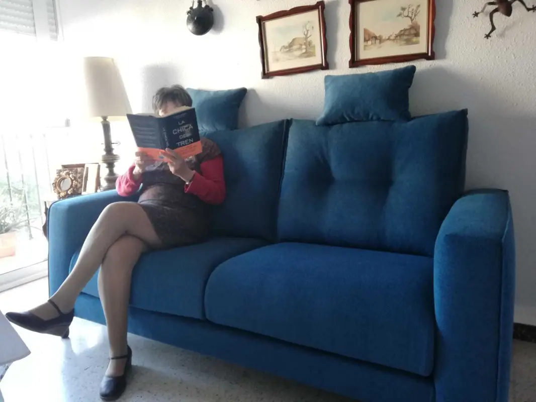 A book, a sofa, two legs