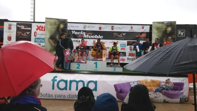 First podium with the athletes sitting on armchairs.